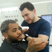 Kevin Gates being served by Celebrity Barber, Barber Mo from SKILLS Dubai Barbershop